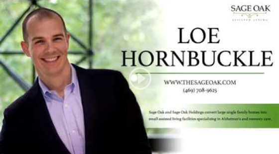 A smiling man in a suit stands in front of a window. Text on the image reads: LOE HORNBUCKLE, WWW.THESAGEOAK.COM, (469) 708-9625 and includes the Sage Oak logo and information about assisted living services.